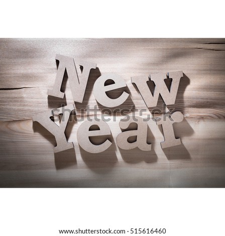 The greeting message "New Year" composed volumetric letters on wooden background.