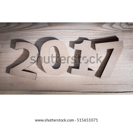 The digits "2017" composed volumetric letters on wooden background.