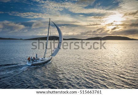 Sailing boat with spinnaker sail on open sea Royalty-Free Stock Photo #515663761