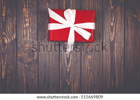 Christmas gift box on wooden background on vintage style. Design cory space. Close-up photo. Minimalism concept