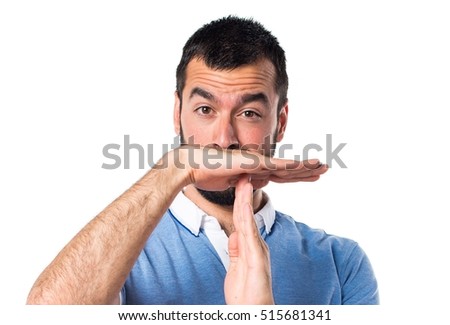 Man with blue shirt making time out gesture