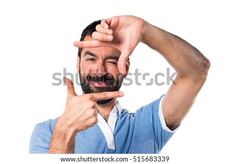 Man with blue shirt focusing with his fingers