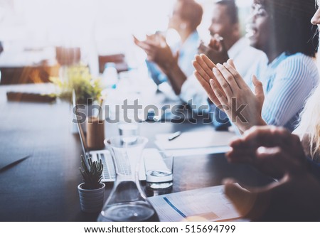 Photo of young business partners applauding to reporter after listening report at seminar. Professional education, work meeting, presentation or coaching concept.Horizontal,blurred background Royalty-Free Stock Photo #515694799