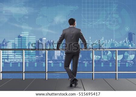 Businessman standing and looking at the city