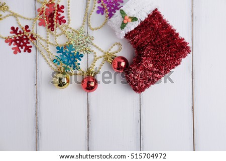 Top view of Happy christmas and Happy new year festival with decoration ornament and sock concept on white wood background. Selective focus and space vintage style.