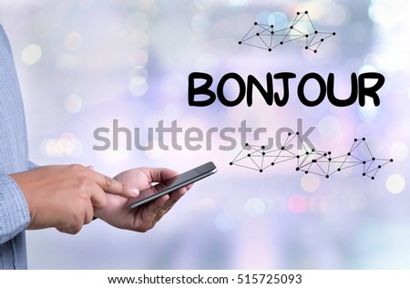 Hi Greet  hi Bonjour Ciao Hola Hello person holding a smartphone on blurred cityscape background
