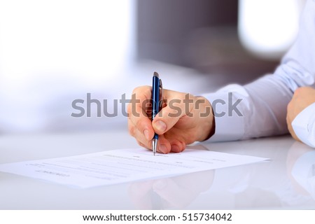 Businessman is signing a contract, business contract details Royalty-Free Stock Photo #515734042