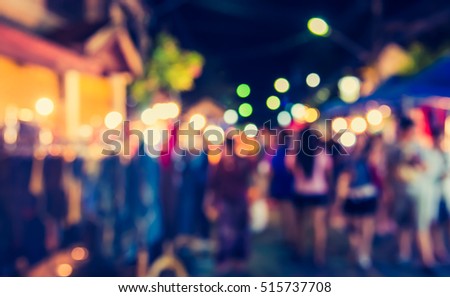 vintage tone blur image of night market on street with bokeh for background usage .