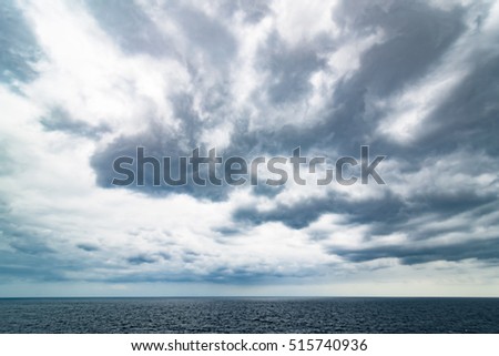 Atlantic Ocean with dramatic blue sky and clouds behind cruiser. 
Cruising along Spanish Canary Islands, view from cruise ship, image for tourism business concept, travel blog photo website