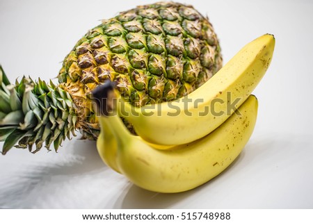 Ripe Pineapple and Bananas on white