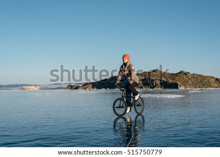 The girl goes on a bmx on the beautiful and dangerous ice.