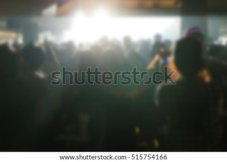Effects blur light Fair:  Dj Picture of rock concert, music festival, New Year eve celebration, party in nightclub, dance floor many people standing with raised hands up and clapping