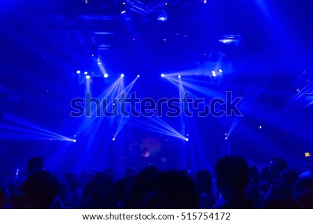 Effects blur Dj Picture of rock concert, music festival, New Year eve celebration, party in nightclub, dance floor many people standing with raised hands up and clapping, 