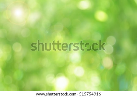 Green blurred backdrop. Abstract background wallpaper with lens flare effect.