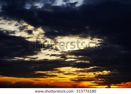 Sunset with yellow horizon, dark blue sea and cloudy sky at Chonburi, Thailand