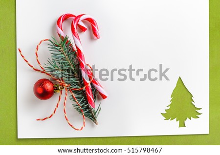 Cut paper in fir-tree shape with decoration for christmas card or new year background on green table