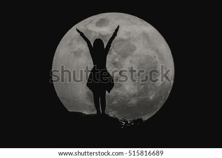 silhouette of young girl with the super full moon : success concept