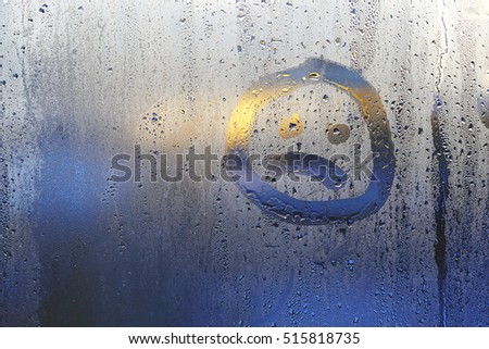 sad face on a wet window glass Royalty-Free Stock Photo #515818735
