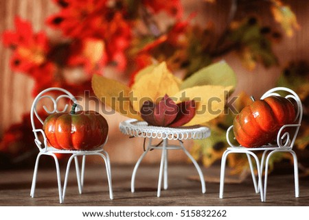 fresh pumpkin in interior wooden room on forged chair