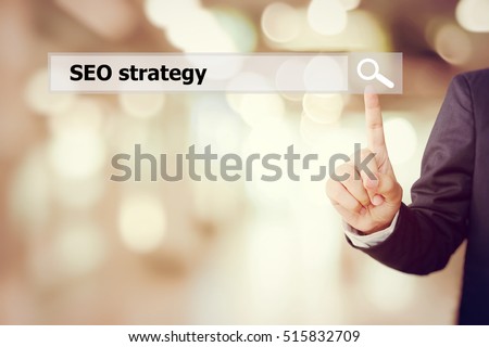 Businessman hand touch screen with SEO, search engine optimization, strategy on search bar over blur background, digital marketing, business and technology concept