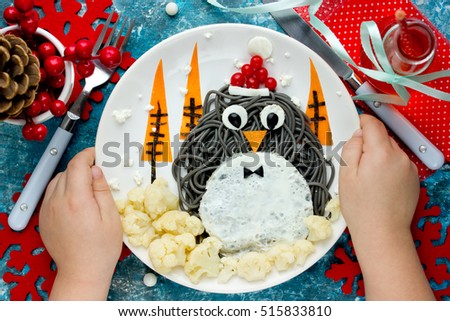 Christmas fun food art idea for kids - penguin black spagehetti with fried egg and vegetables