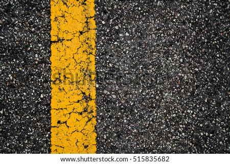Yellow lines on asphalt texture/ background.