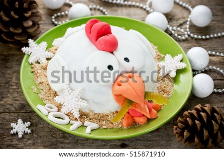 Rooster cake (cock cake, hen cake, chicken cake, bird cake) - festive cake shaped Red Fire Rooster simbol New Year 2017 on Chinese calendar. Merry Christmas and Happy New Year 2017 food background