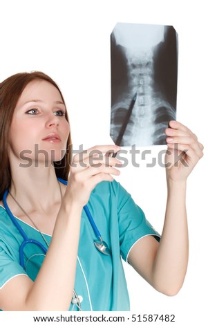 Portrait of thoughtful female doctor in the green uniform looking at the x-ray image.