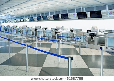 The public check-in area of an airport with crowd control barriers Royalty-Free Stock Photo #51587788