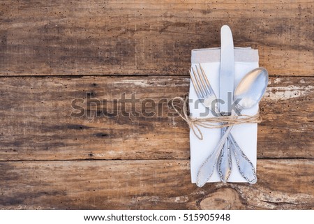 Rustic table setting, old silver cutlery with napkin