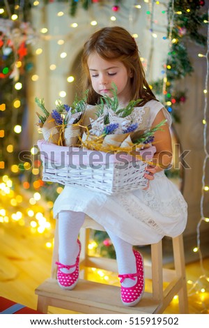 girl considers Christmas jewelry, a set of bright sparks at a background