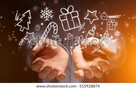 Concept view of Hands of a man holding christmas icons 