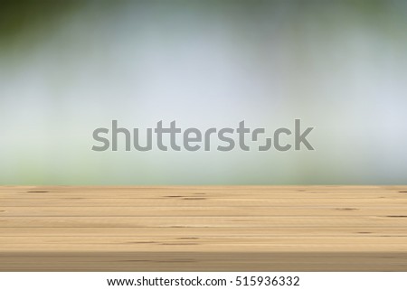 Wood table top on blur nature background, used for montage or display your products