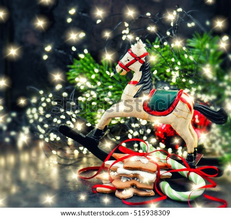 Christmas lights decoration, rocking horse and cookies. Vintage style toned picture. Selective focus