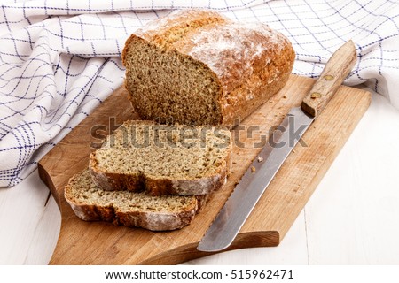 sliced traditional irish soda bread on a wooden board with bread knife Royalty-Free Stock Photo #515962471
