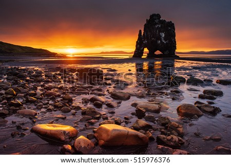 Hvitserkur is a spectacular rock in the sea on the Northern coast of Iceland. Legends say it is a petrified troll. On this photo Hvitserkur reflects in the sea water after the midnight sunset. 