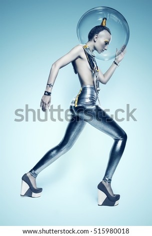 walking cyborg woman in silver suit and helmet on blue background