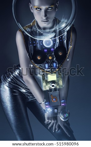 space woman in silver suit and glass helmet in dark