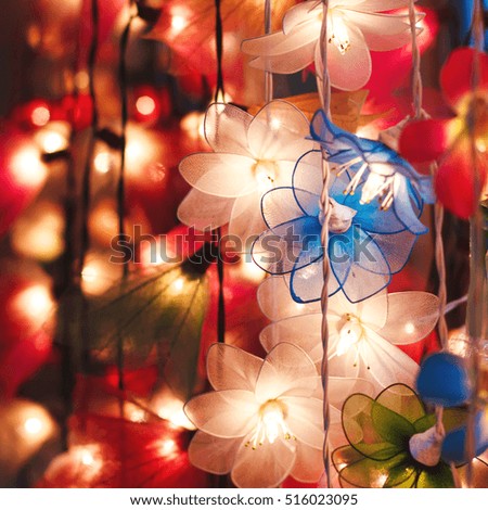 Flower garland lightning, colored illumination, festive mood, selective focus
