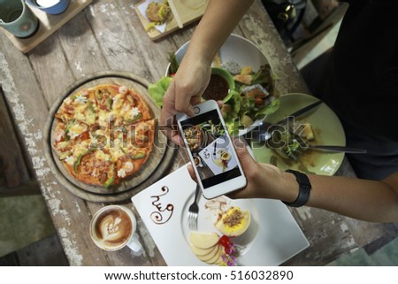 Taking photo of food with smartphone , mobile photographer
