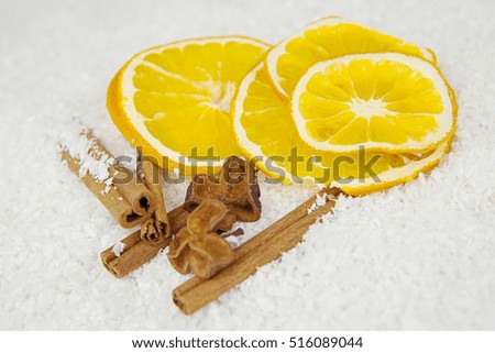 dried slice of orange, cinnamon stick and star anise over white background