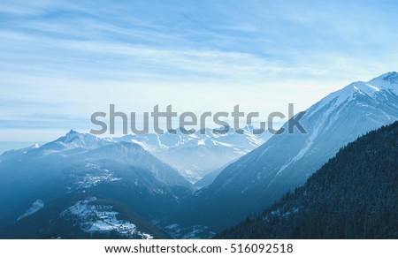Beautiful winter landscape mountains Alps in Switzerland with clouds and blue sky. Panorama