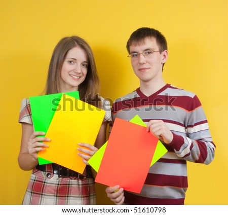 Two young pepople with white banners on yellow backgroung