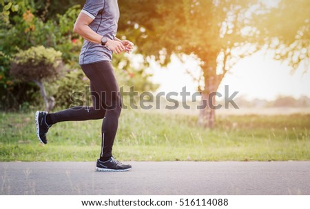  Young man is running on road sunset. 
