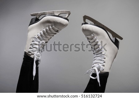 Girl in a new white skates for skating on ice 