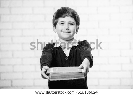 Close up  portrait of cute european boy with book.