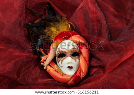 Carnival mask isolated on red fabric background