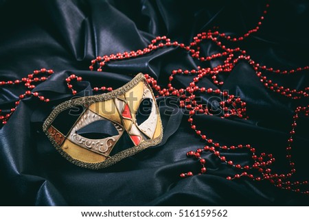Carnival mask isolated on black satin background