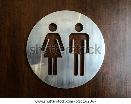 Man and Woman toilet sign or symbol. Circle stainless steel man and woman toilet symbol. Mobile Photography