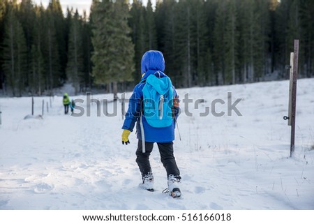 They say there are is no bad weather, just bad clothing. Kids are enjoying winter elements with their parents. Concept photo of children growing up with nature. 